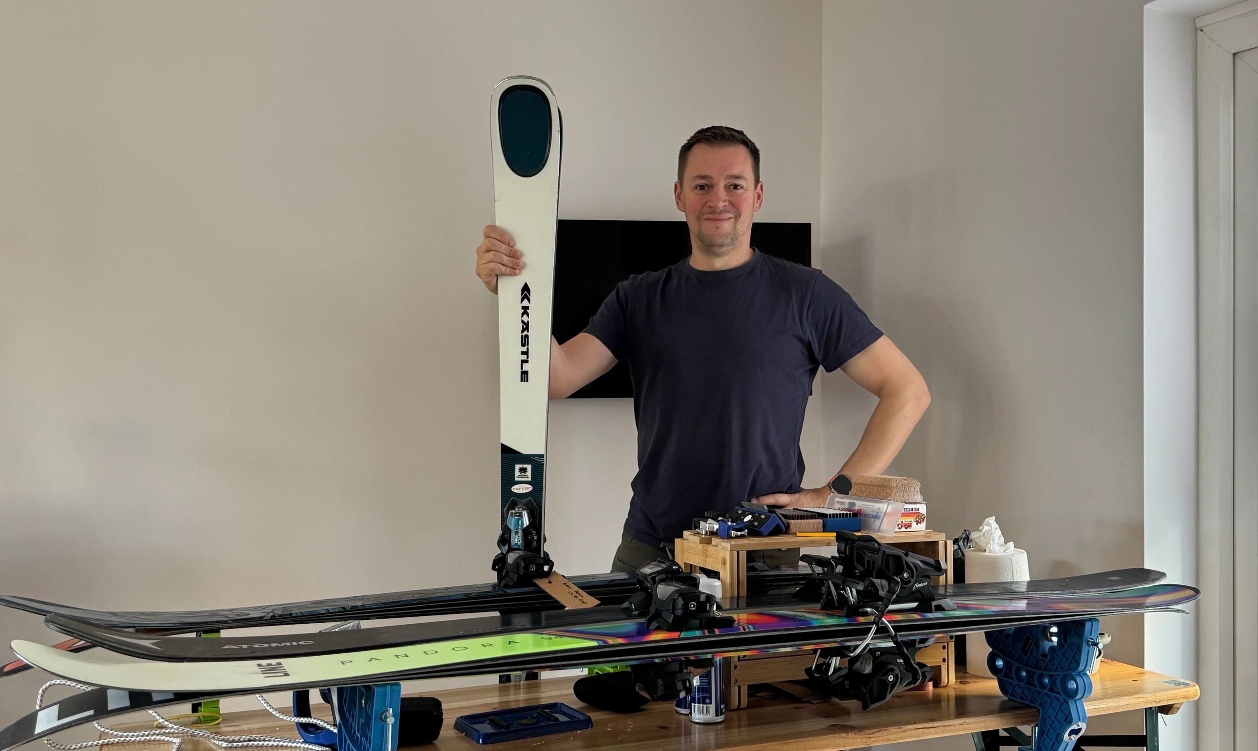 JC10 Ski Tuning technician with skis and snowboards in South West London workshop